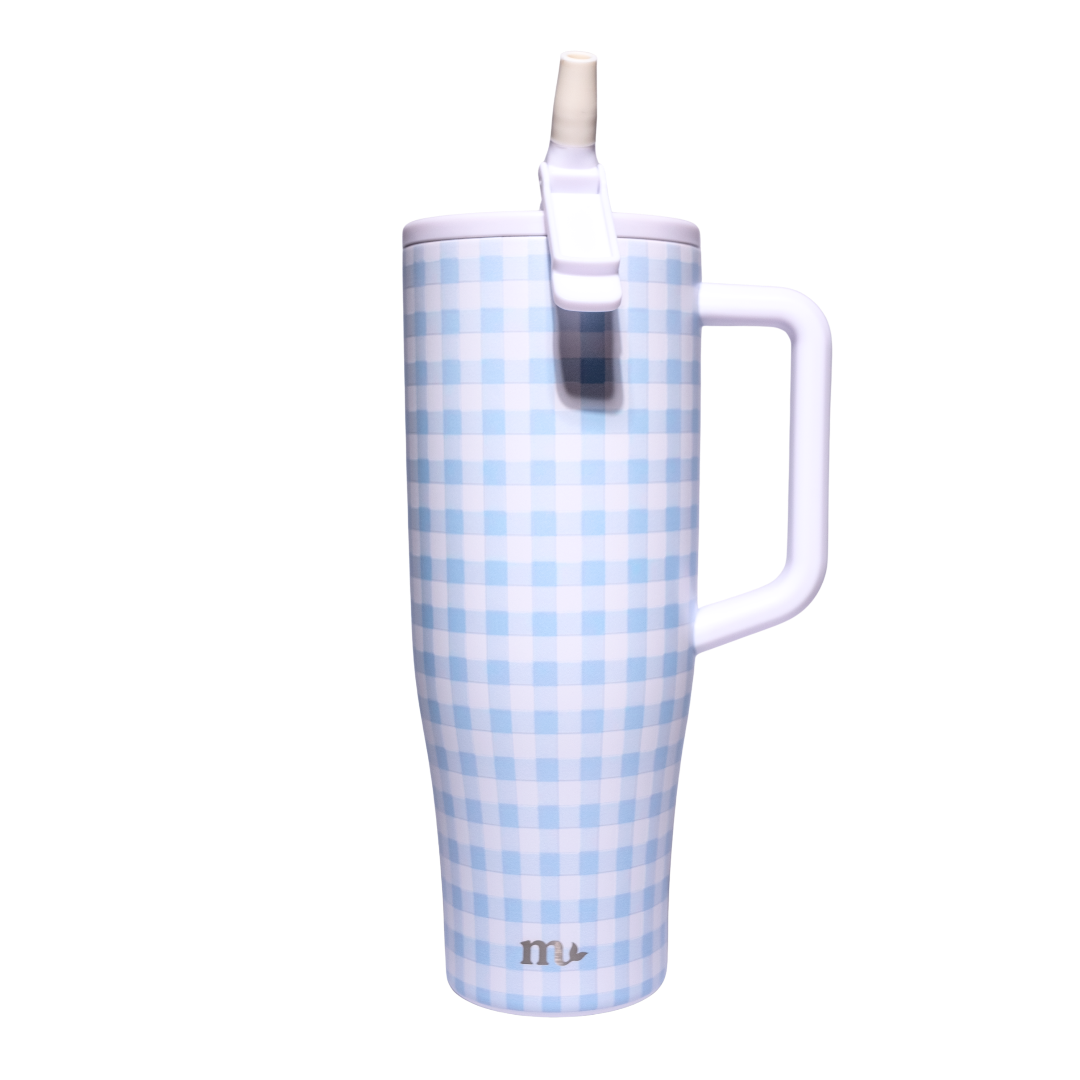 A tall handled tumbler with a light blue and white gingham check pattern, featuring a white lid with a flip-up straw and a small silver logo near the bottom.